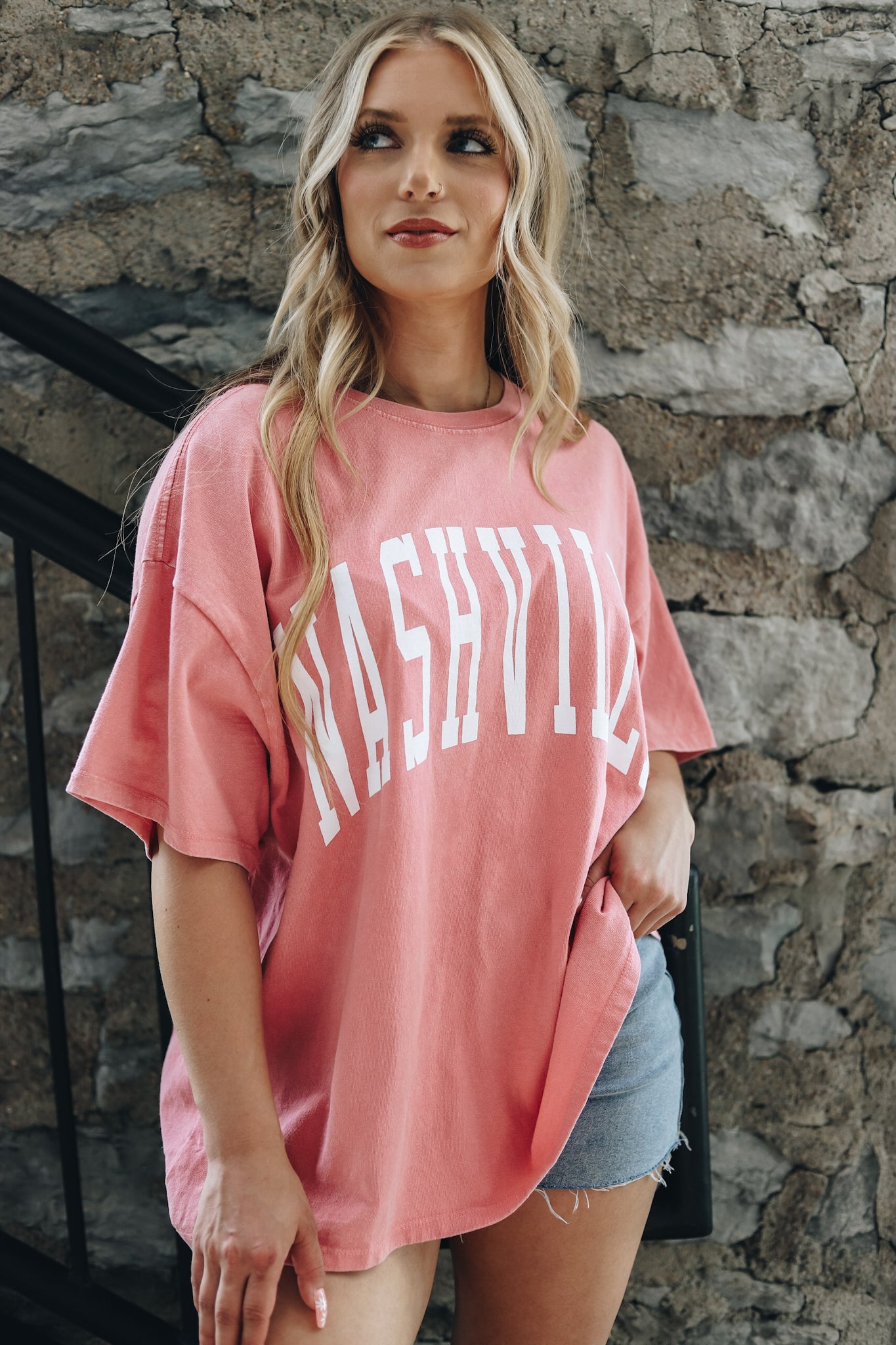 Shay wearing the kacey oversize tee in coral, with cut off shorts  