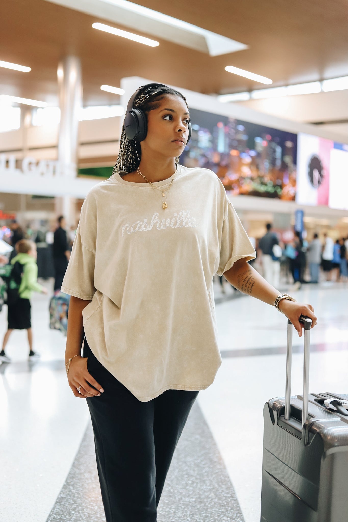 Model wearing the oversize tee while traveling at the airport