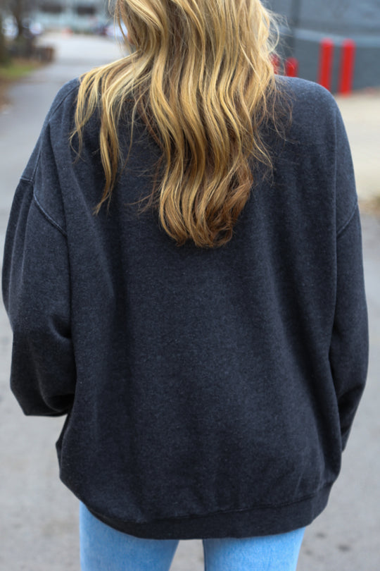 Back view of Black oversized vintage wash crewneck with oversized ‘nash’ screen printed on the front 