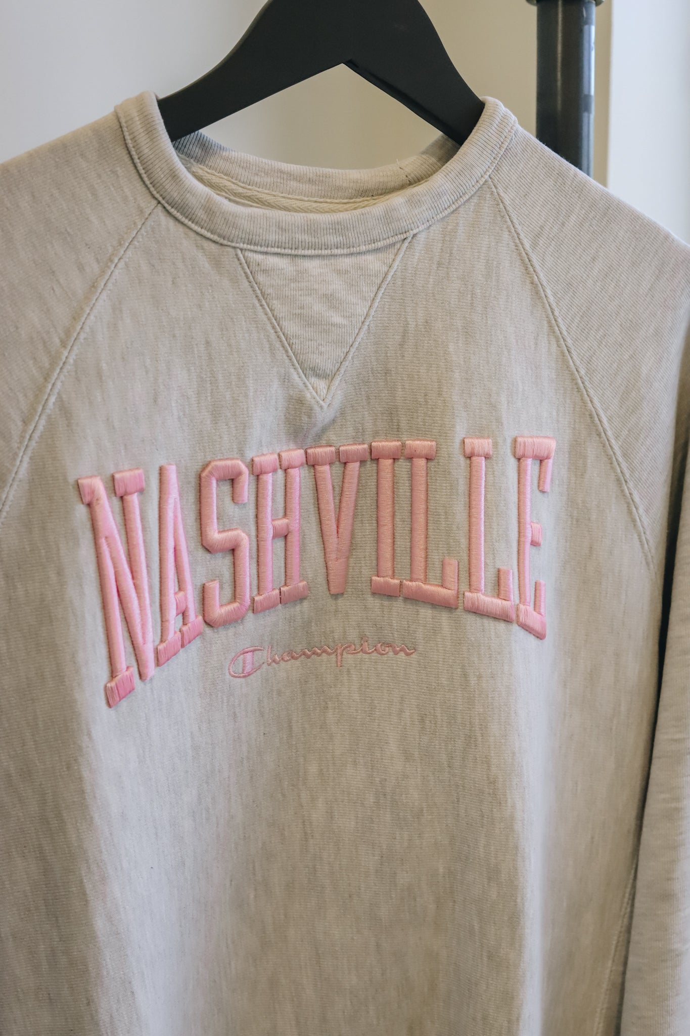 Up close view of the champion vintage wash embroidered crew in gray 