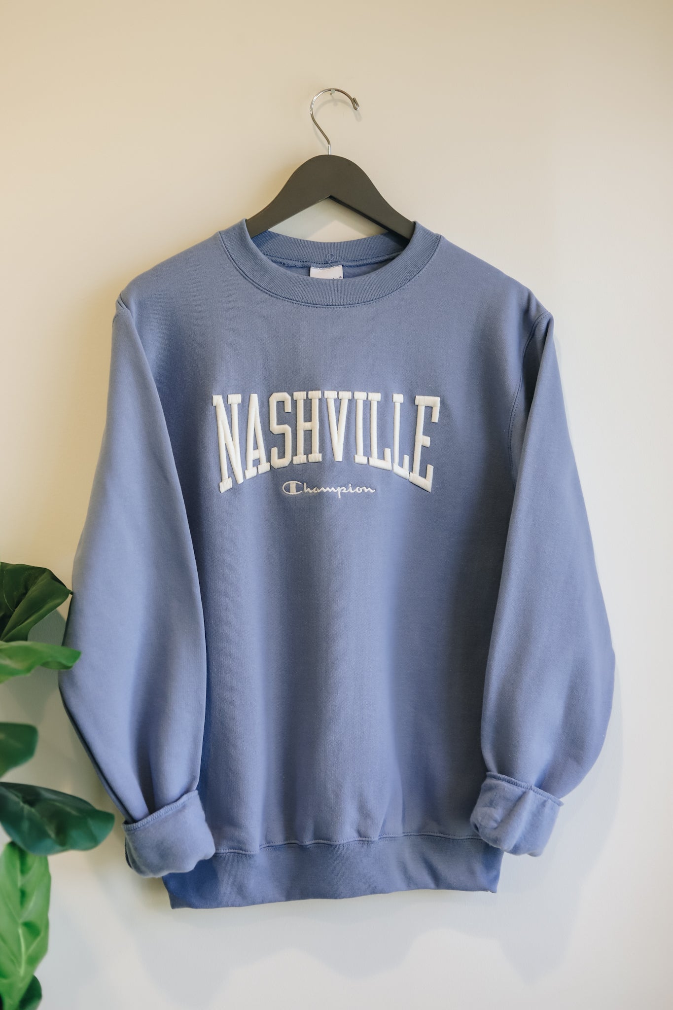 Hanging photo of the denim blue powerblend crewneck with 3D Nashville embroidered across the front. 
