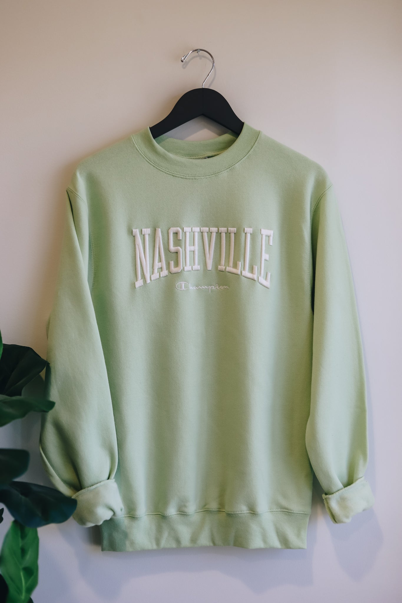 Hanging photo of the light green powerblend crewneck with 3D embroidered Nashville across the chest. 