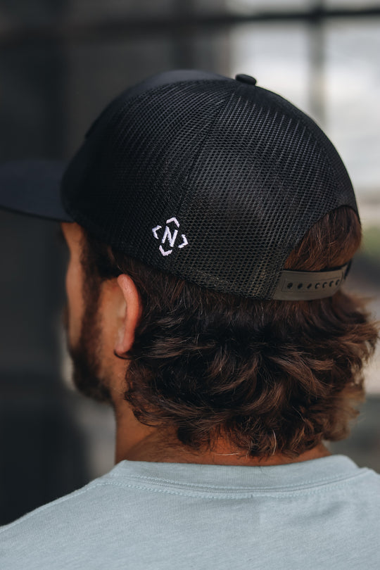 Back view of the Up close view of the NASH Est. 1806 Trucker in black with our Iconic logo on the side 
