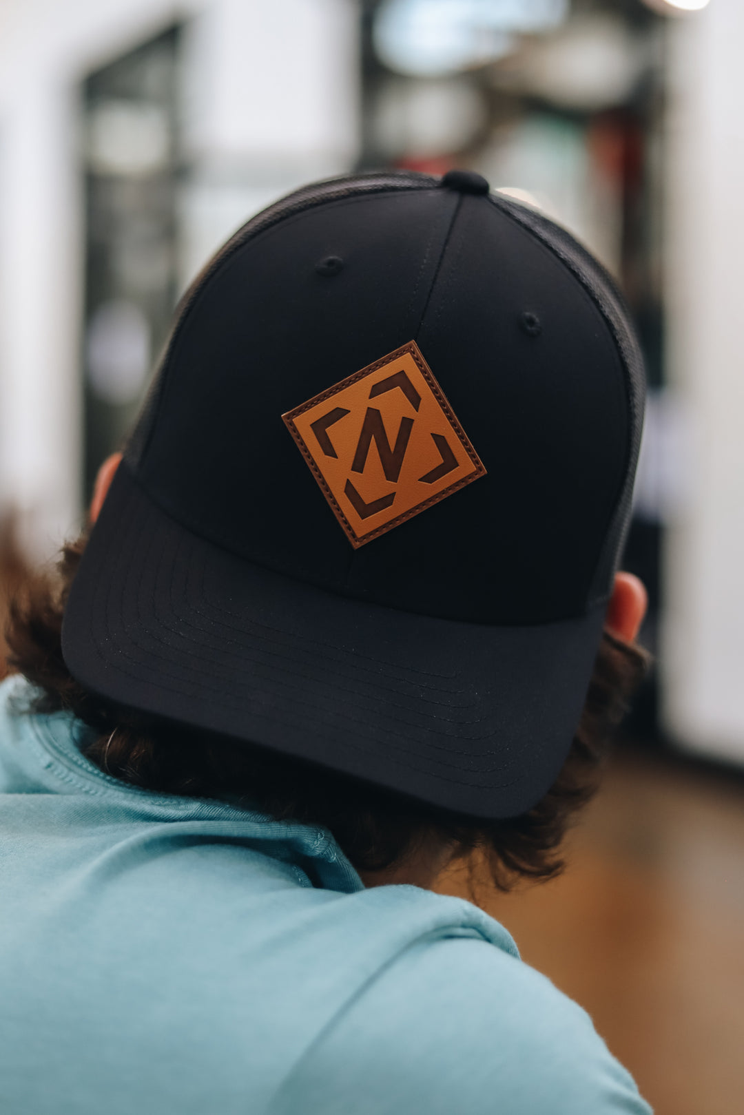 Close up view of the black iconic leather patch trucker 