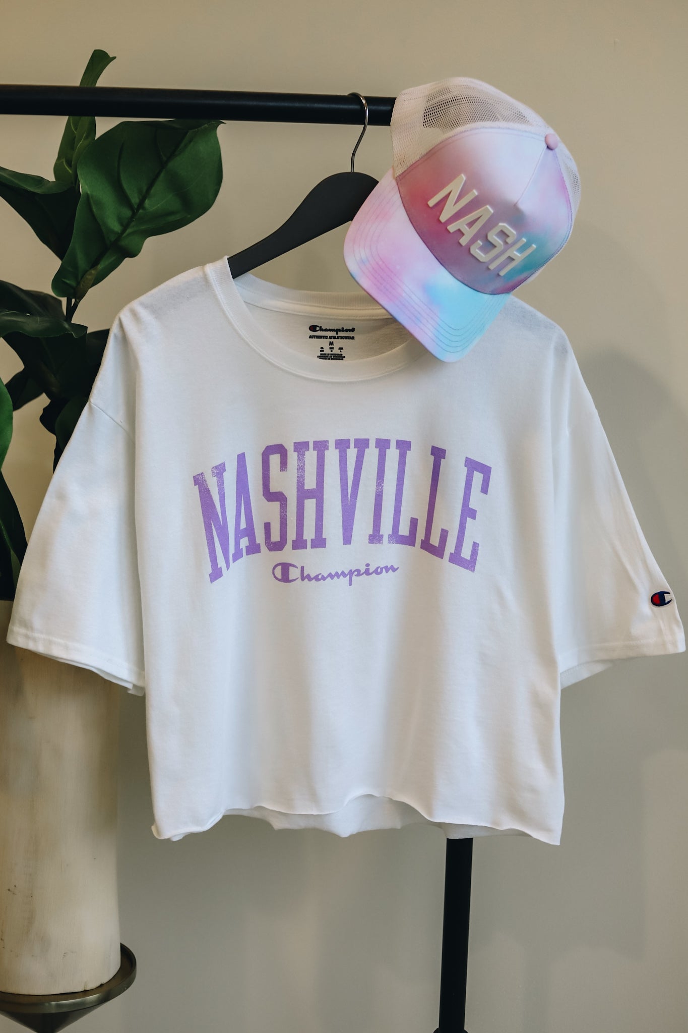 Hanging photo of the white/lilac boxy crop tee