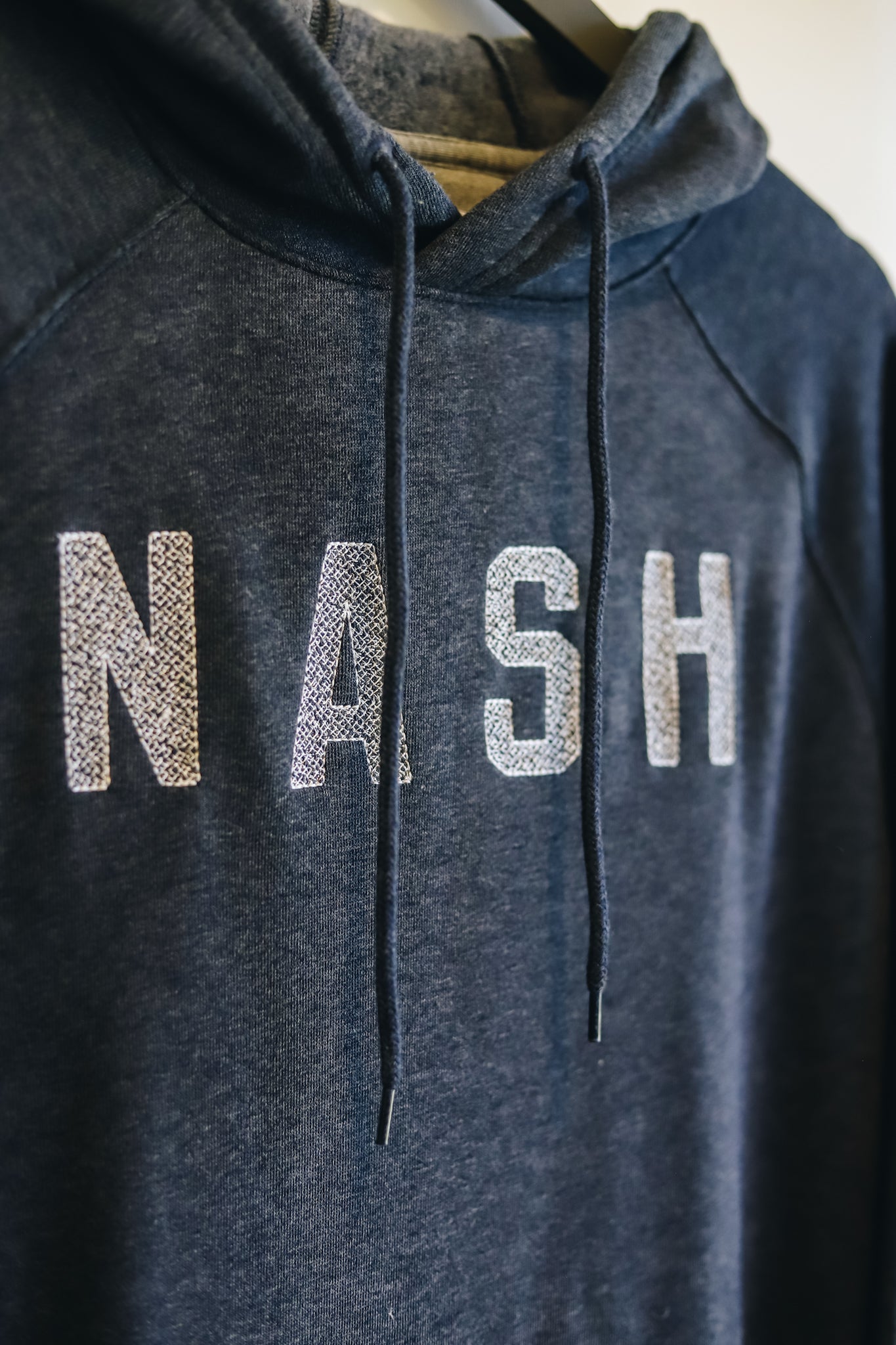up close view of the embroidery on the Everyday NASH Hoodie [Navy]