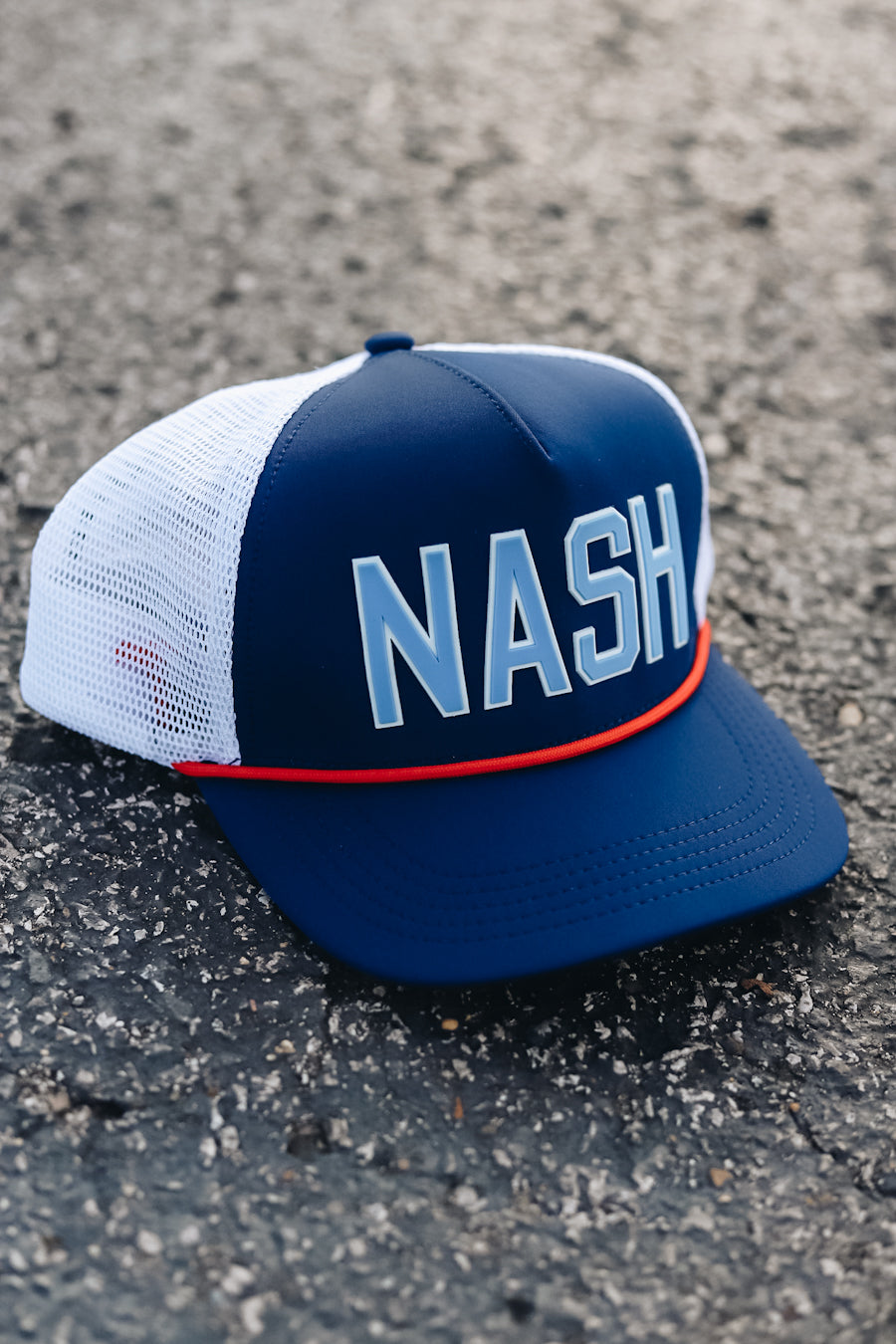 Navy neoprene trucker with light blue and red accents for Tennessee Titan games. 