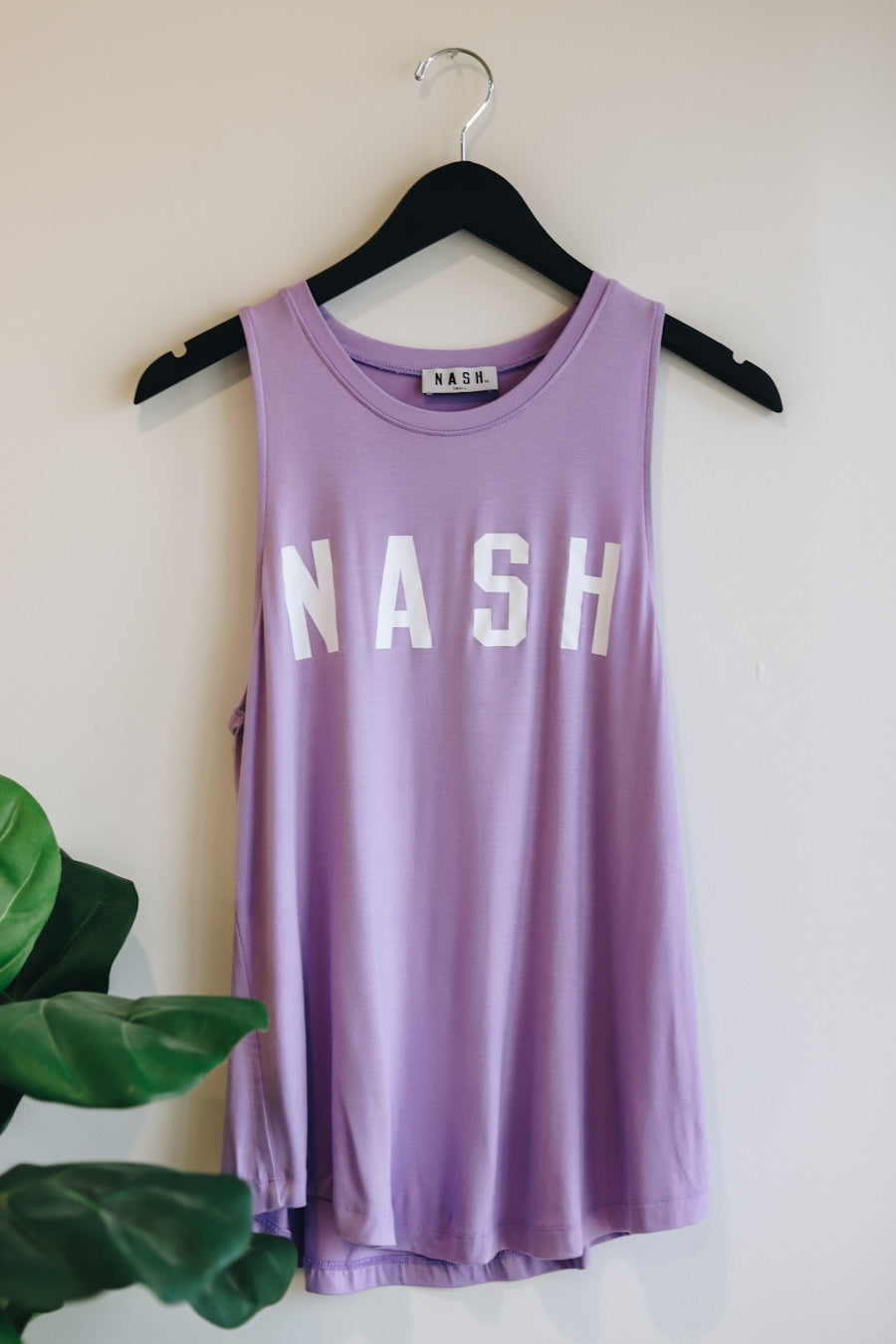 Product image of the lilac racerback summer tank with white nash screen printed on the front. 