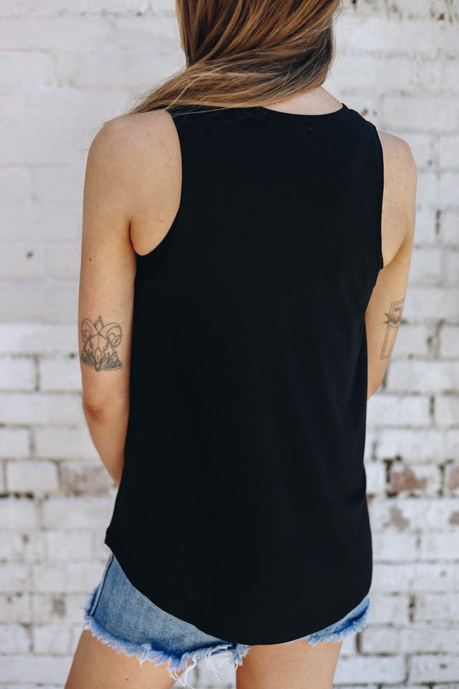 Back view of the black racerback tank with pink NASH printed on the front