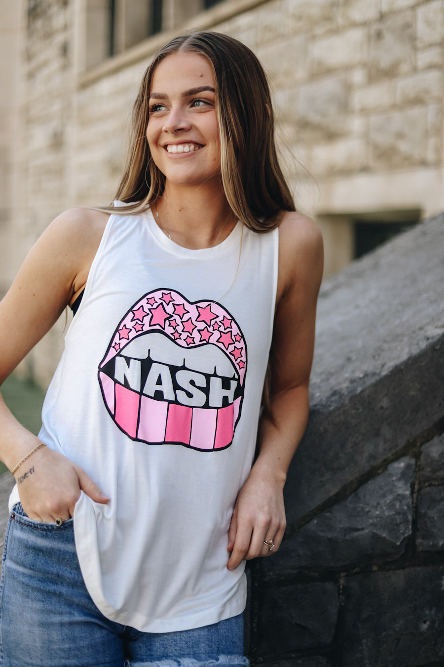 Casen modeling the white racerback tank with a pink lips nash design