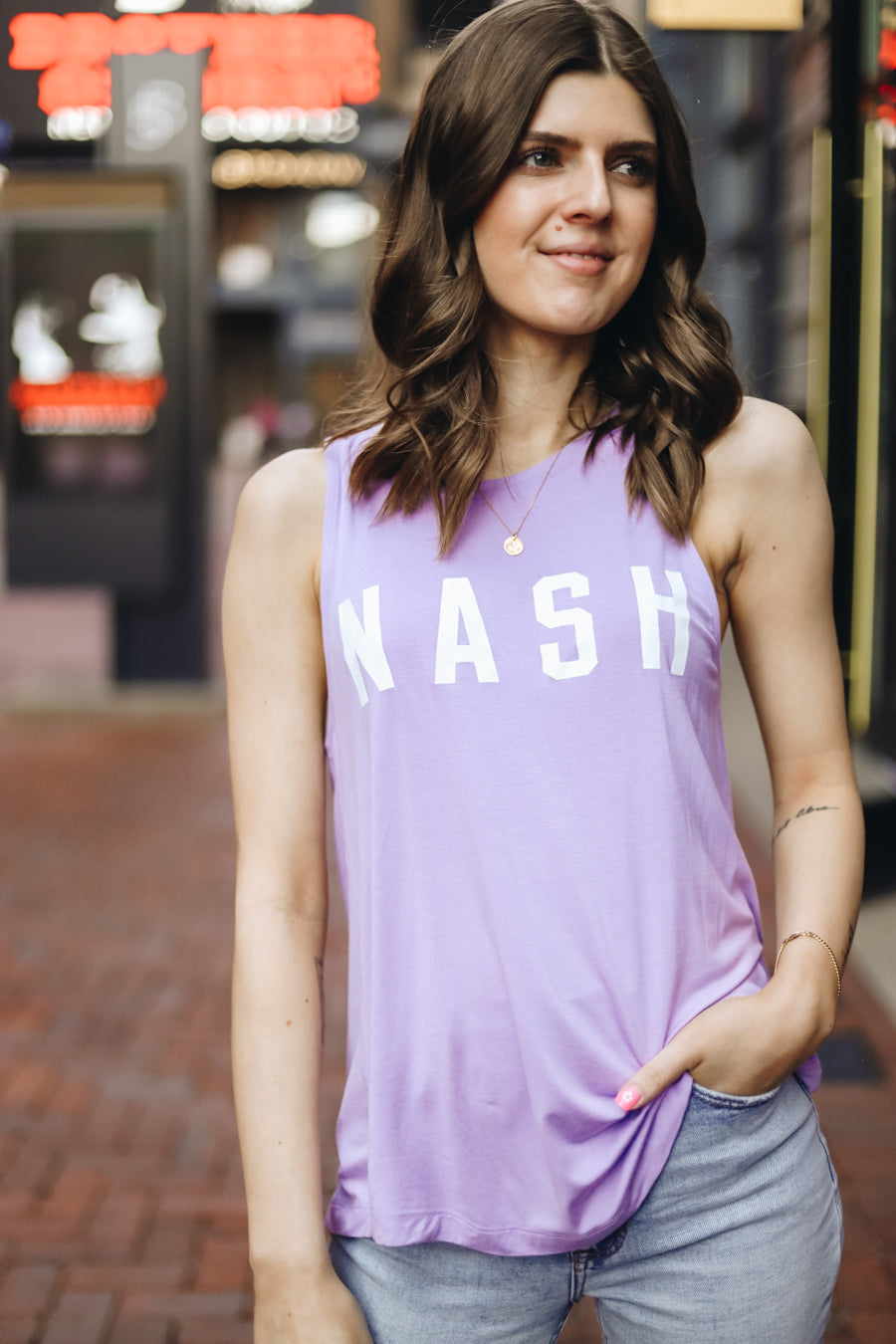 Kat modeling the lilac racerback summer tank with white nash screen printed on the front. 